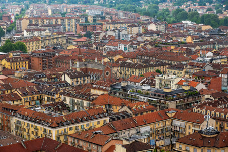 Aerial scene of Torino showcasing red-tiled rooftops of historic buildings and a scenic neighborhood.の写真素材