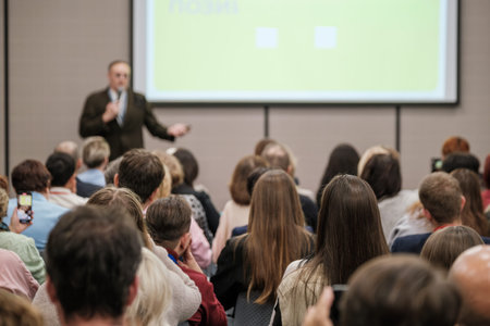 Business presentation in conference room, focused audience listening to speaker, lecture and public...