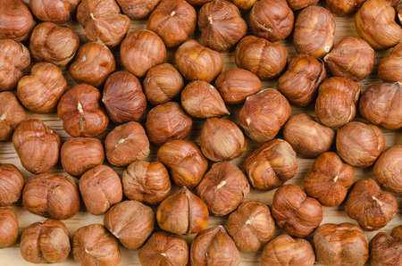 toasted hazelnuts without shells, on wood, backgroundの写真素材