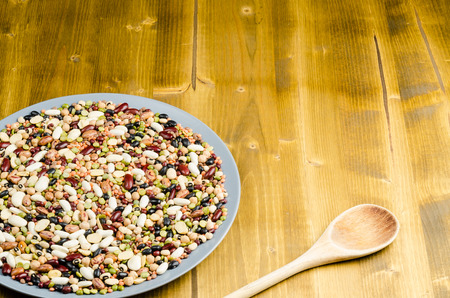 legumes in a dish close up on wood background
