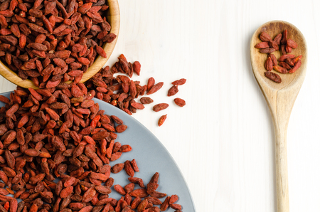 Goji berry dried in a dish with spoon closeup backgroundの写真素材