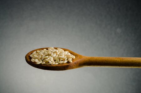 rice in a spoon, close up, color backgroundの写真素材