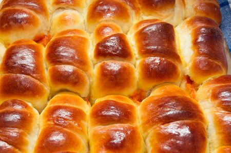 A tasty croissant with jam made from rose hip jam.の写真素材