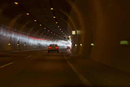 Road tunnel to the hills under the mountains.の写真素材