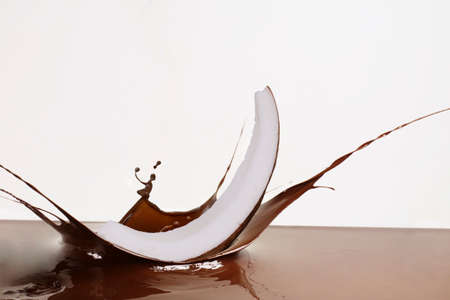 coconut and splashing melted dark chocolateの写真素材