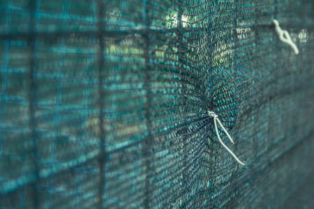 Macro photo of a wire fastened to the safety fence on a construction siteの写真素材
