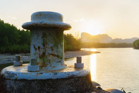 Old mooring bollard in port at sunlight morning.