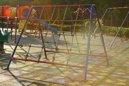 Children playground  activities in public park at sunlight morning. Children run, slide,...
