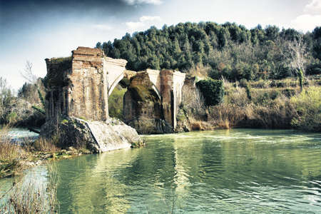 Old bridge destroyed in the Tuscan hills の写真素材