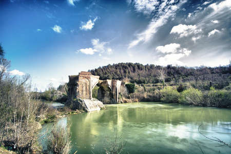 Panorama of the Old bridge destroyed in the Tuscan hills, with beautiful sky,  Italy の写真素材