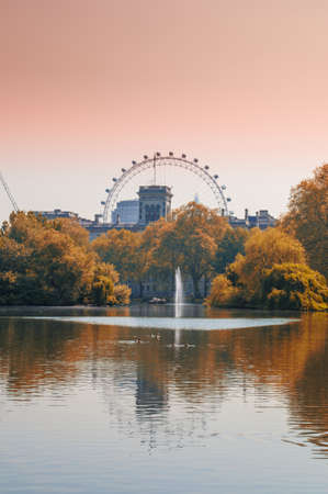 London Eye reflected in the lake in St  James Park, London の写真素材