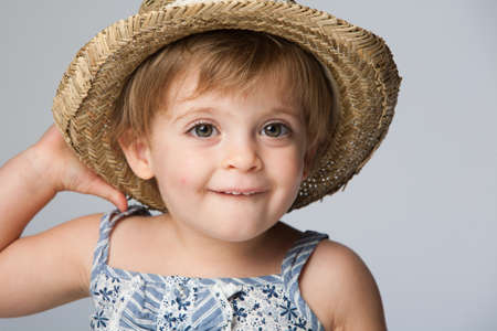 Close-up of a girl standing with Straw Hat.のeditorial素材