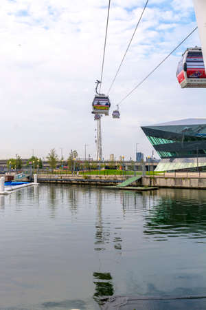 LONDON - SEPT 29: Visitors travel on Emirates Air Line cable cars. The service is the UK's first urban cable car running across the Thames from the O2 to the Excel Center September 29, 2013 in London UK .のeditorial素材
