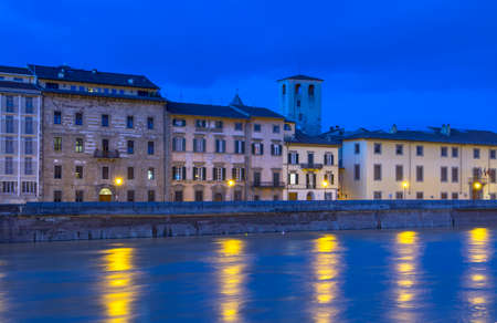 Pisa by night alon the river Arno.の写真素材