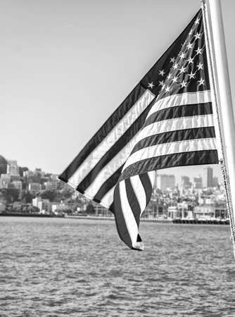 USA Flag with in background skyline of San Francisco.の写真素材