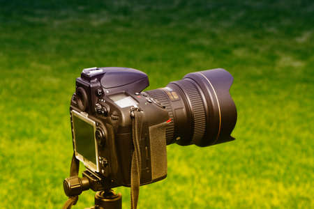 Digital camera on background of a garden.の写真素材