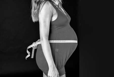Pregnant woman measuring your belly.の写真素材