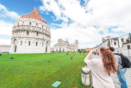 PISA, APRIL 30: Tourists visit Piazza dei Miracoli , April 30, 2014 in PIsa. Leaning Tower and Baptistery and Dome are a Unesco World Heritage site.のeditorial素材