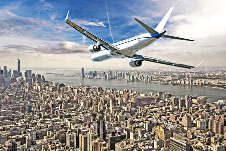 Airplane flying over  New York City.の写真素材