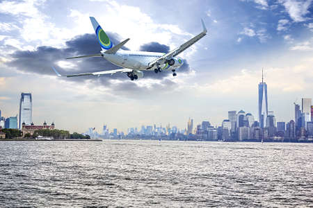 Airplane flying over  New York City.の写真素材
