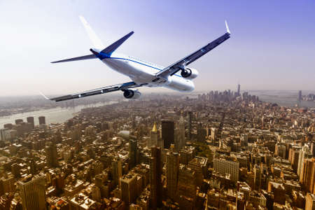 Airplane flying over  New York City.の写真素材