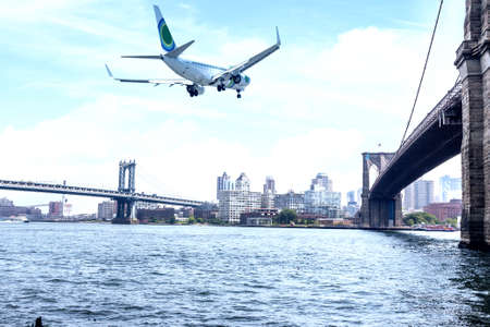 Airplane flight over Brooklin Bridge, NYC.の写真素材