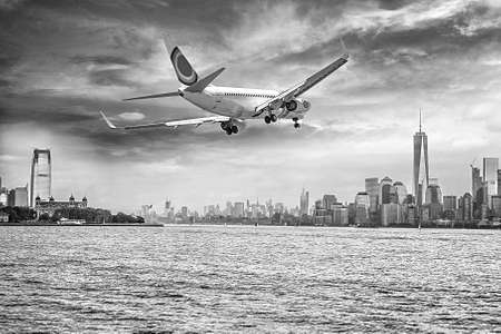 Airplane flying over  New York City. の写真素材