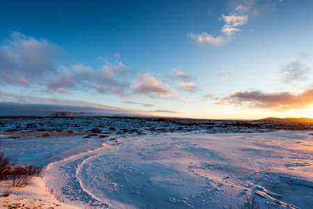 Sunset on icelandeic tundra with snow and ice.の写真素材