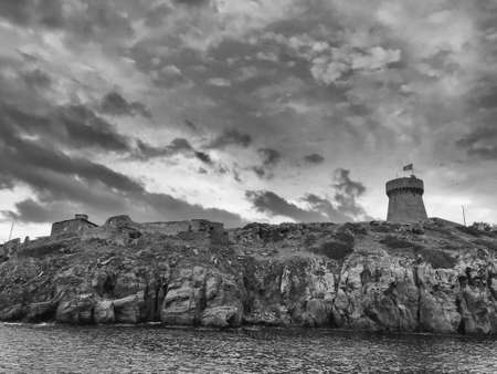 Old tower over the cliff at sunset.の写真素材