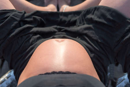 Pregnant woman seen from above.