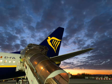 PISA, ITALY, DICEMBRE 12, 2018: Ryanair plane ready to harness at sunset. Ryanair is the major...