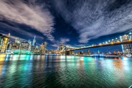 Skyline of Manhattan and Brooklyn bridge, night view.の写真素材