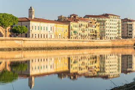 Sunset on the banks of the Arno River, Pisa, Italy.の写真素材