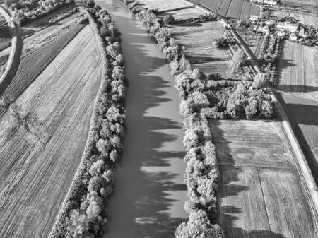 Aerial view of river Arno between cultivated fields.の写真素材