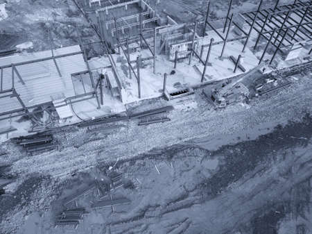 Aerial view of a construction site with heavy machinery for material lifting.の写真素材
