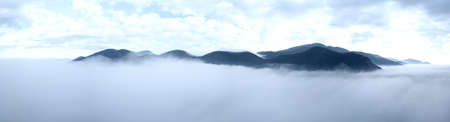 Panoramic aerial view of a mountain in the fog, Tuscany, Italy.の写真素材