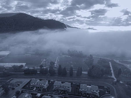 Clouds and fog over the town, Tuscany.の写真素材