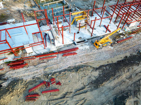 Aerial view of a construction site with heavy machinery for material lifting.の写真素材