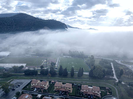 Clouds and fog over the town, Tuscany.の写真素材