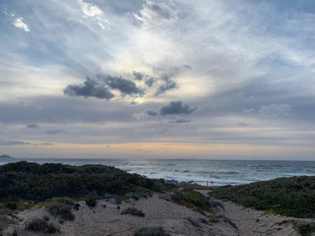 Sunset with beautiful cloudy skies among the sand dunes, Sardinia, Italy. の写真素材