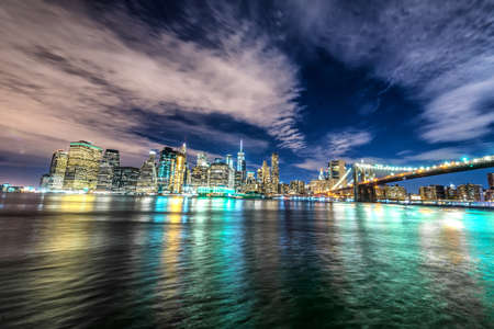 Skyline of Manhattan and Brooklyn bridge, night view.の写真素材