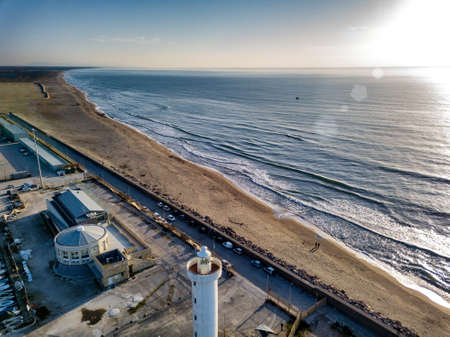 Aerial view from drone of lighthouse near harbor entrance.の写真素材