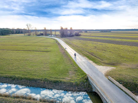 Motorcycle ride in the Tuscan countryside, lights and reflections.の写真素材