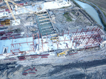 Aerial view of a construction site with heavy machinery for material lifting.の写真素材