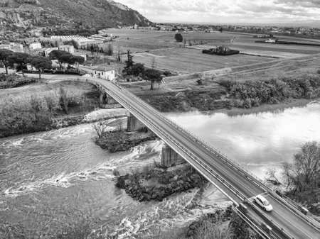 Aerial view of a bridge over the Arno river with the passage of cars, Pisa, Tuscany.の写真素材