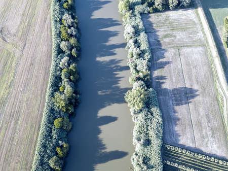 Aerial view of river Arno between cultivated fields.の写真素材