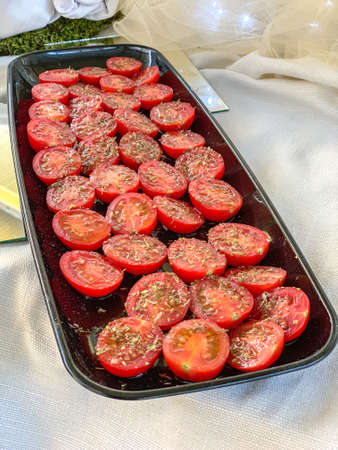 Food concept: cherry tomatoes with spices on wood chopping board.の写真素材