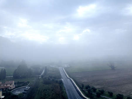 Aerial view street in the fog, Tuscany.の写真素材