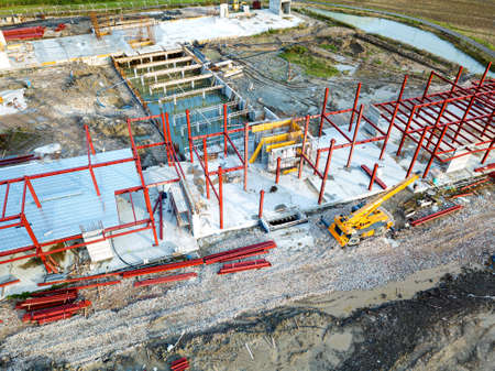 Aerial view of a construction site with heavy machinery for material lifting.の写真素材