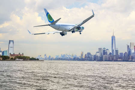 Airplane flying over  New York City. の写真素材